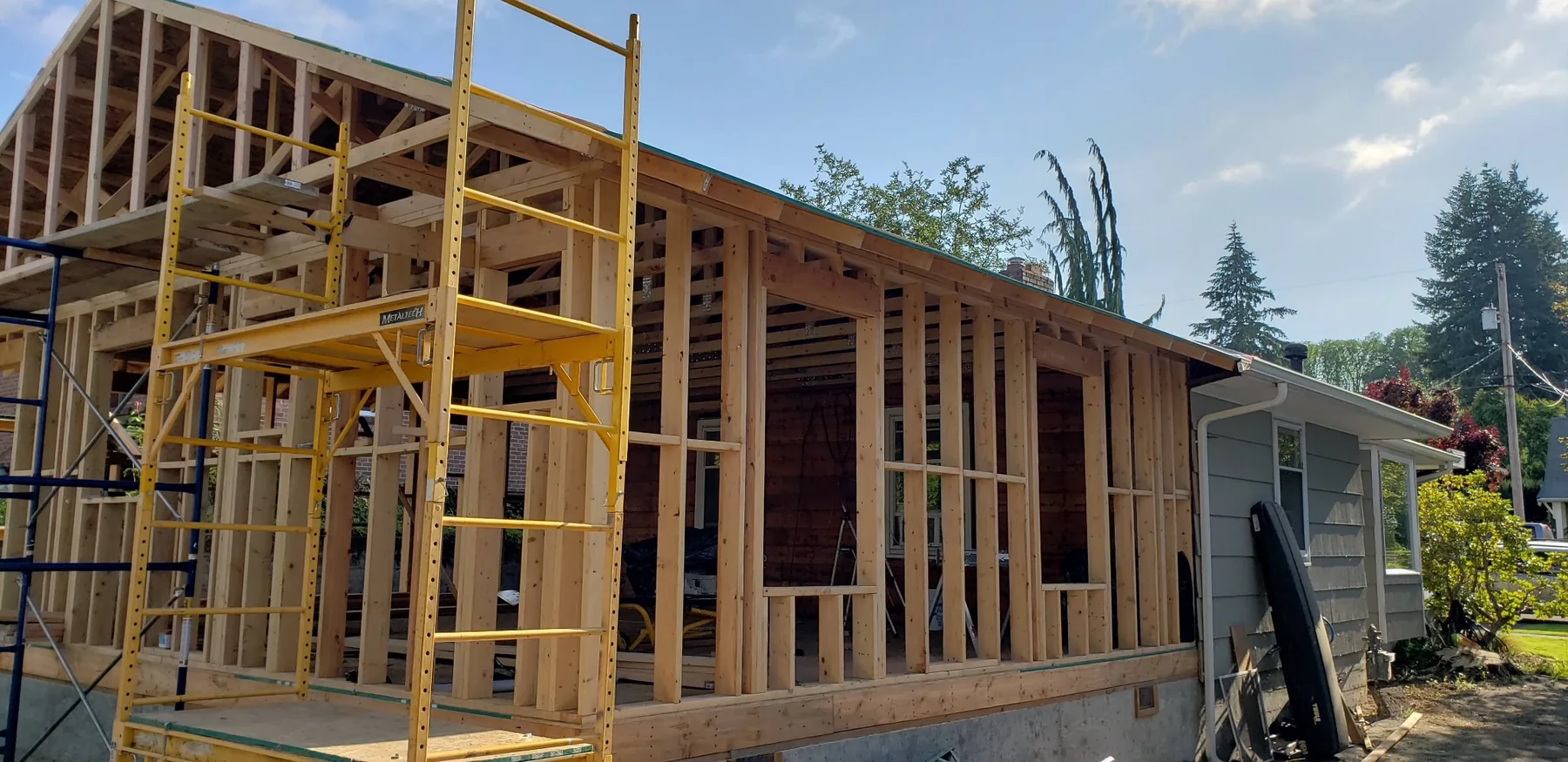 Wood-framed residential addition connected to an existing home