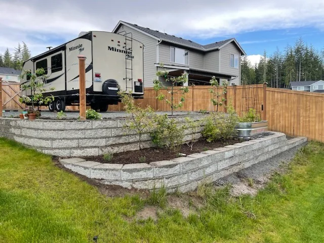 Completed multi-tier block retaining wall with central composite steps