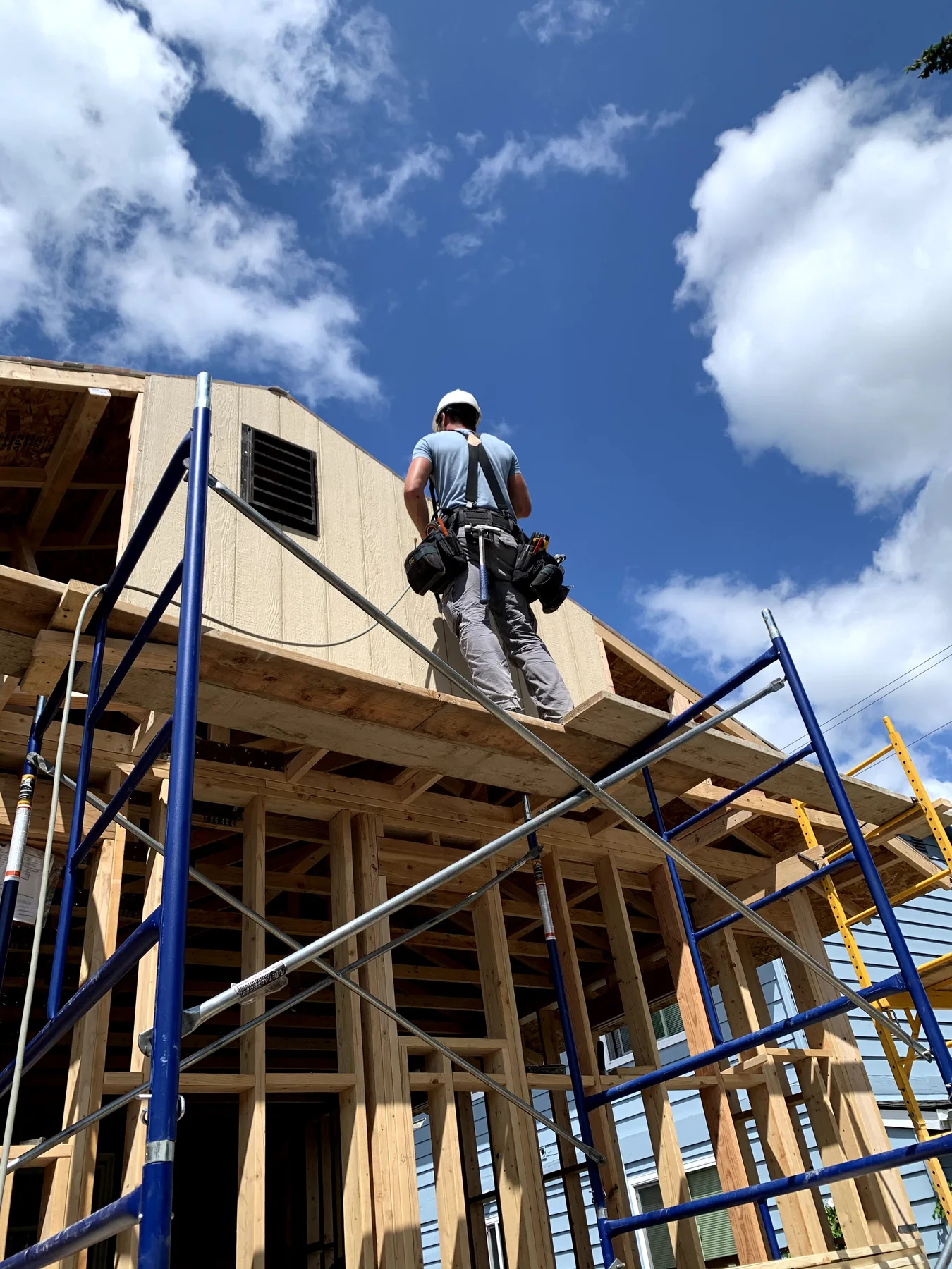 Grizzly carpenter working on a framed home addition