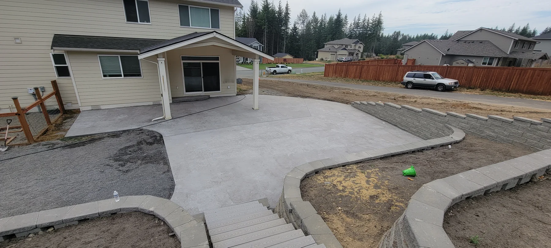 Finished concrete patio, steps and terraced retaining wall