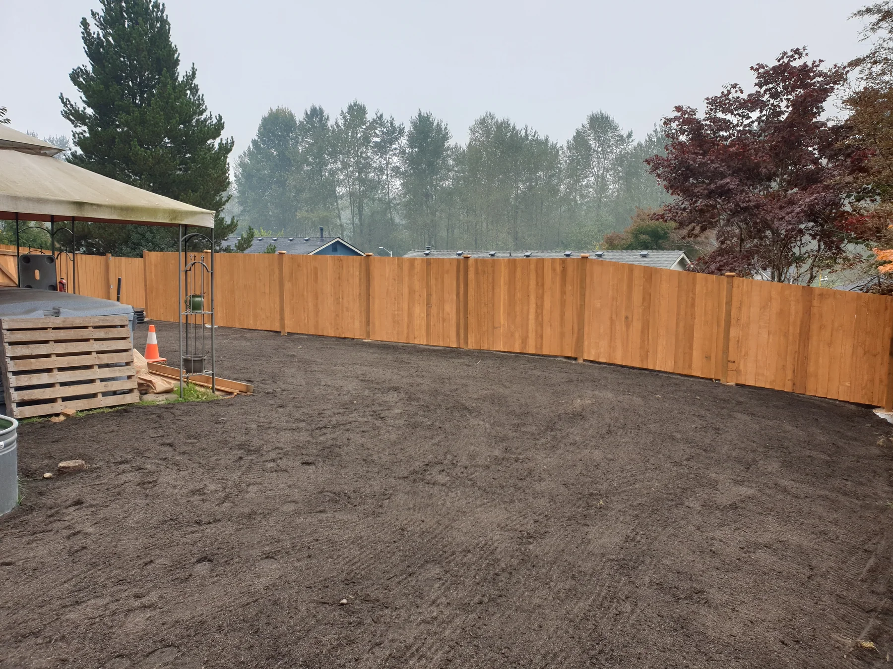 Long newly installed cedar privacy fence around a residential yard