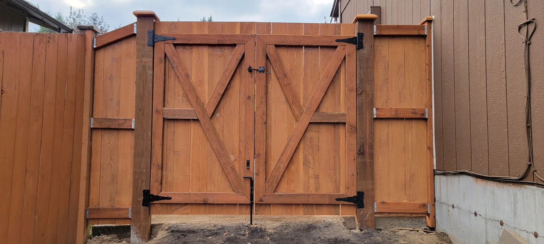 Custom double cedar gate installed in a matching privacy fence
