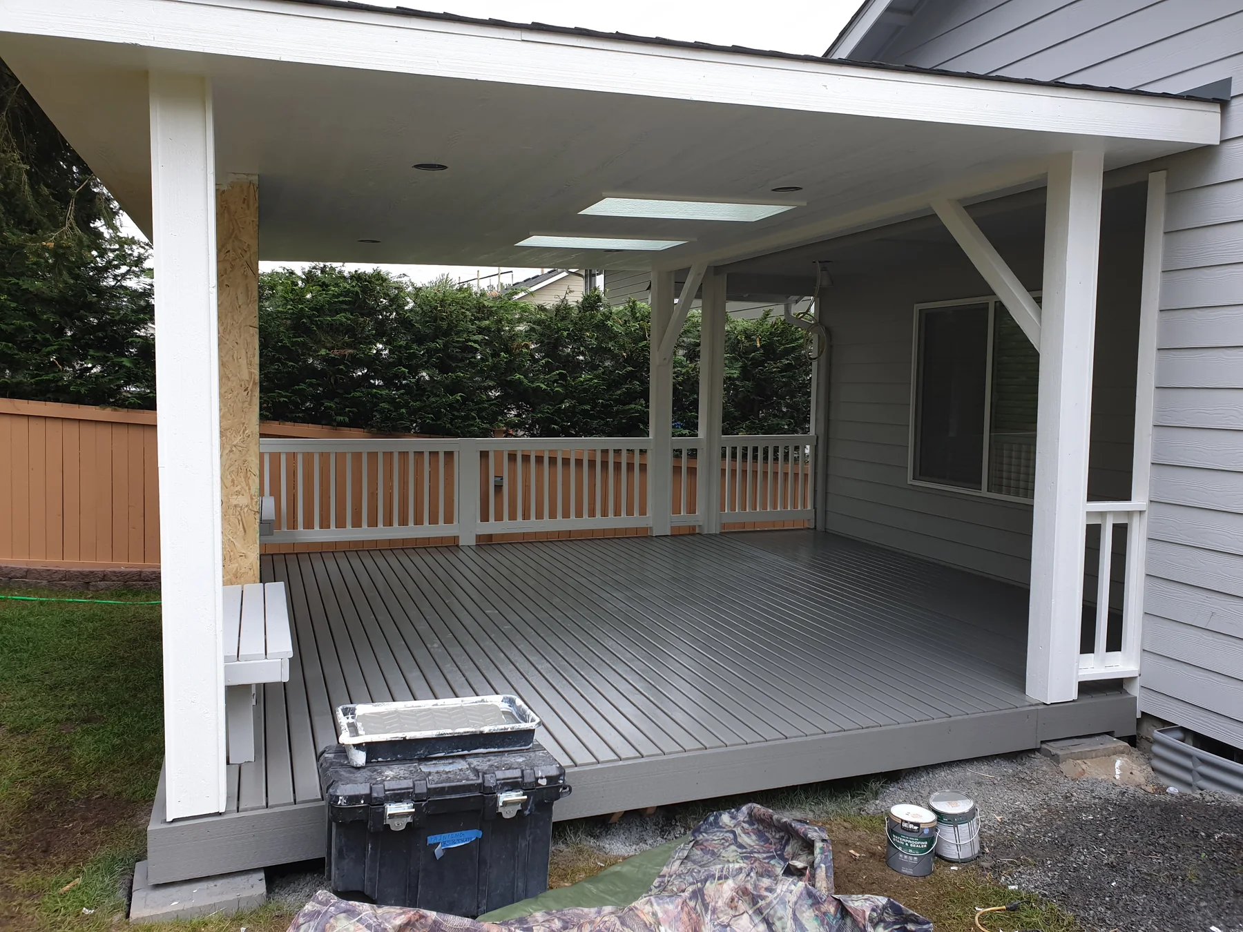Covered backyard deck with skylights and painted structural posts